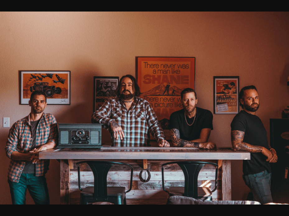 Shane Terrell & The Stumblers at a rustic table with vintage radio and movie posters